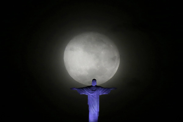 Big moon pictured with Christ the Redeemer statue