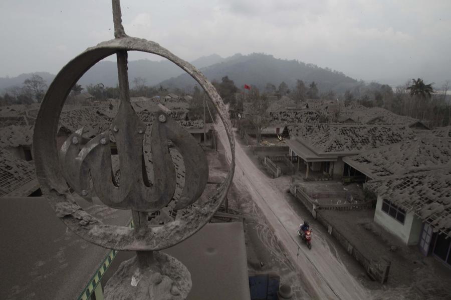 People clear volcanic ash in Indonesia