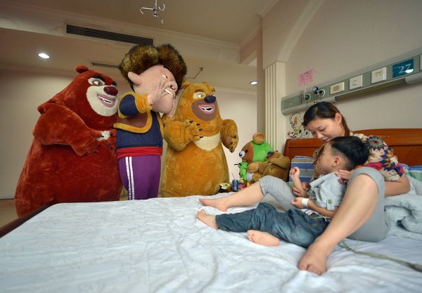 Cartoon characters visit brain tumor boy