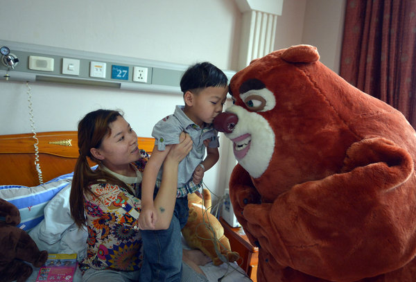 Cartoon characters visit brain tumor boy