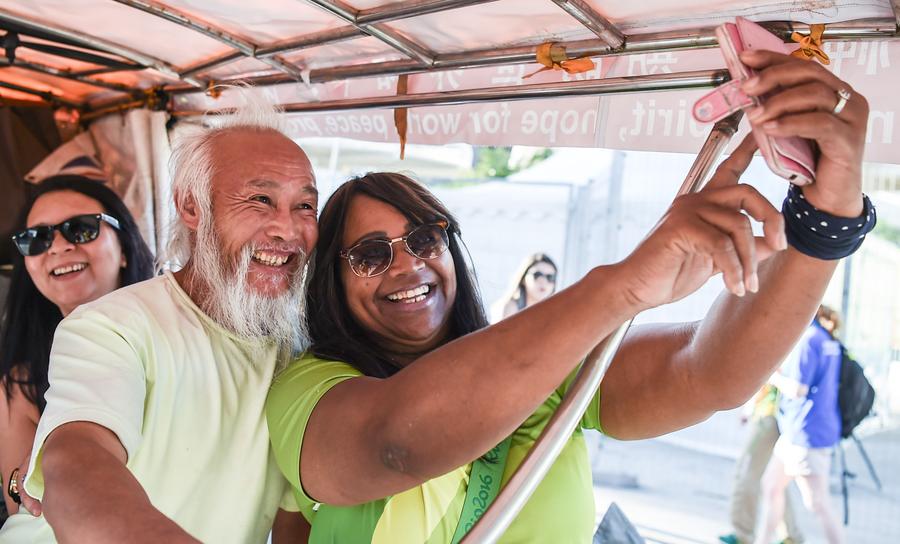 Chinese pedicab rider tours Olympics