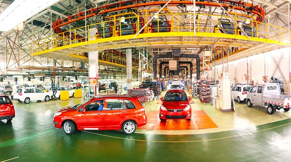 Cars roll off a production line