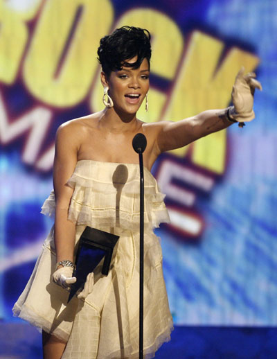 Rihanna stands up in the crowd after winning her second award