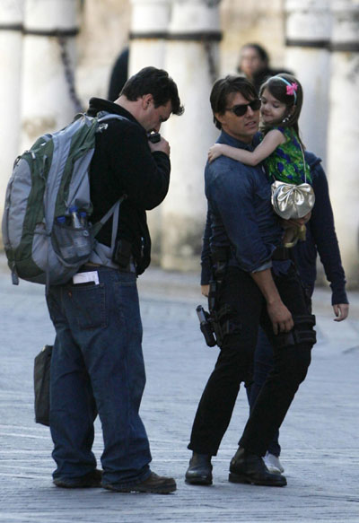 Tom Cruise holds Suri during a break in filming in Seville