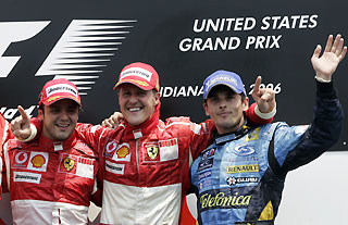 Ferrari Formula One driver Felipe Massa (from L-R) of Brazil, Michael Schumacher of Germany and Renault's Giancarlo Fisichella of Italy celebrate on the podium after the U.S. Formula One Grand Prix in Indianapolis July 2, 2006. 