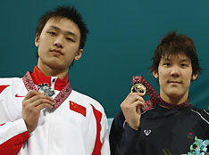 Silver medallist Zhang Lin of China, gold medallist Park Tae-hwan of South Korea and bronze medallist Takeshi Matsuda of Japan pose with their medals during the award ceremony 