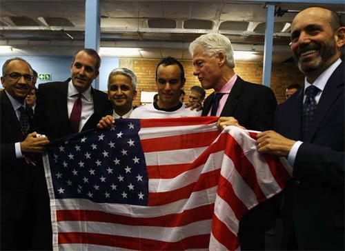 Changing room visitor Clinton praises US spirit