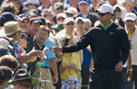 Woods tames course as charm offensive continues