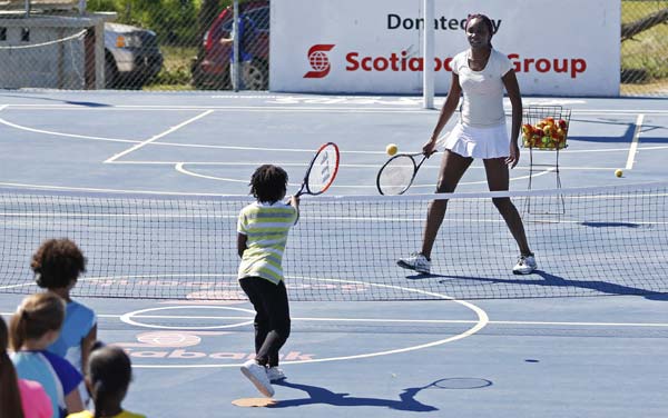 Williams sisters, Olympic sprinters join in tennis clinic