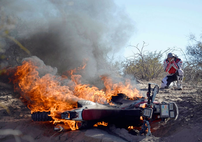 Paulo Goncalves' bike in flames in Dakar Rally