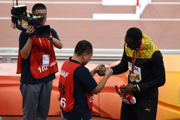 Bolt 'somersaults' after cameraman takes him down