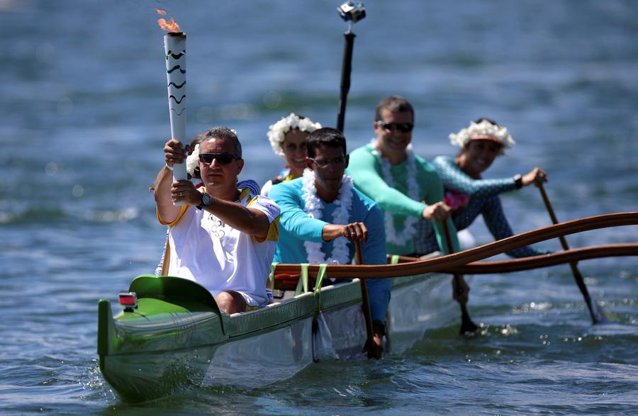 Olympic flame lands in Brazil for 94-day relay to Games