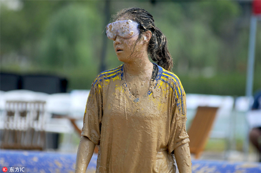 Swamp soccer: Players battle for ball in Nanjing