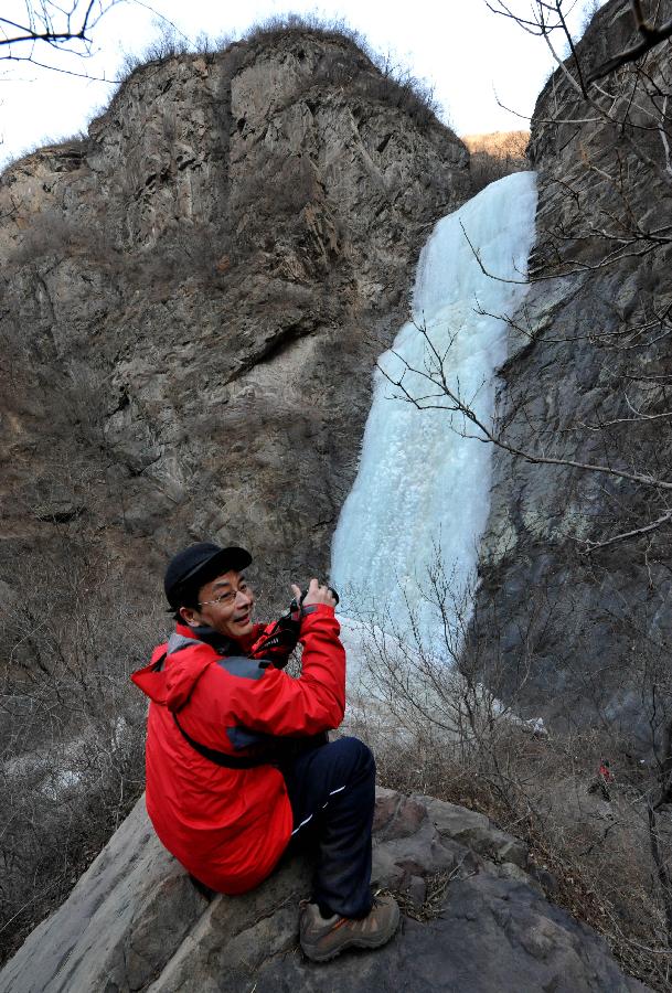 Tourists do ice climbing on frozen waterfall in suburb of Beijing