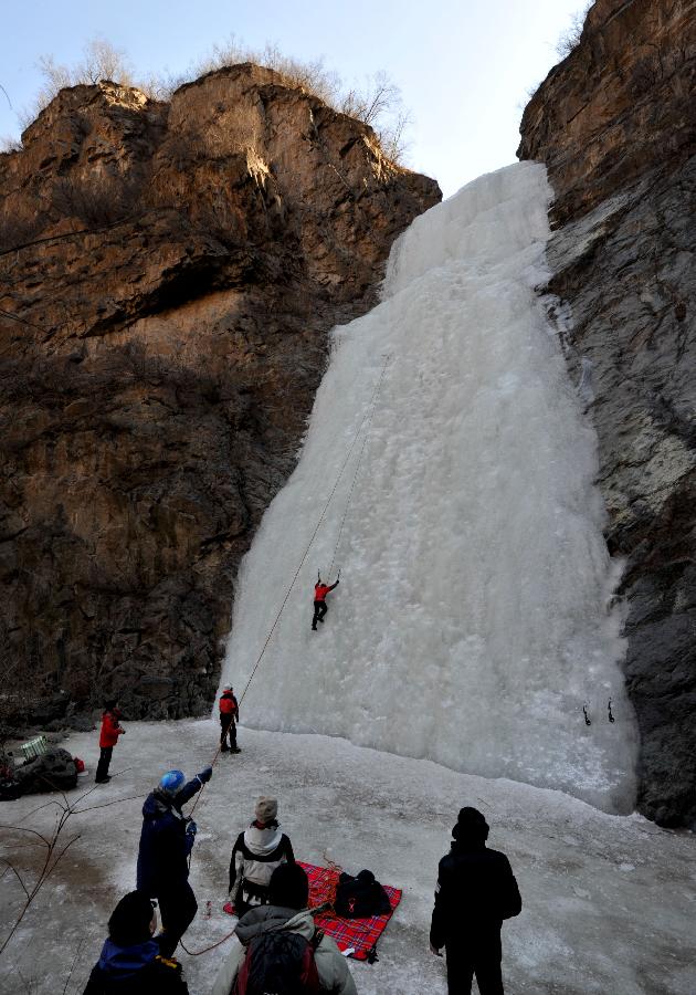 Tourists do ice climbing on frozen waterfall in suburb of Beijing