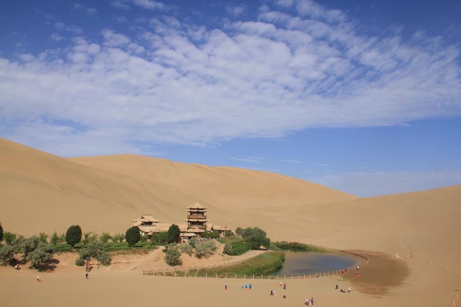 Tourists visit Mingsha Mountain in Dunhuang