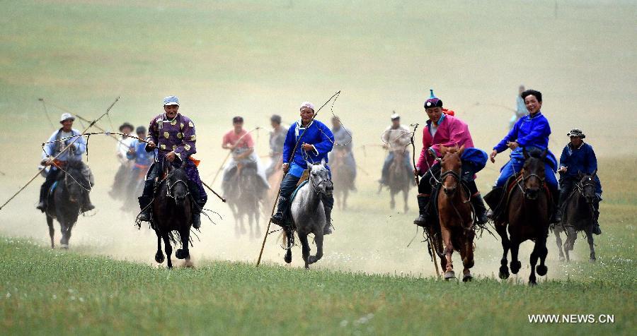 Equestrians ride on grassland of China's Inner Mongolia