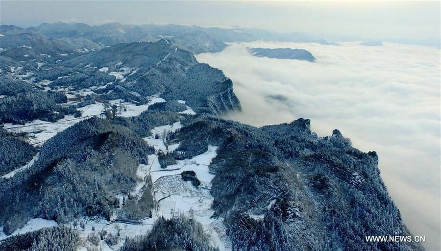 Sea of clouds seen over snow-covered mountains in Hubei