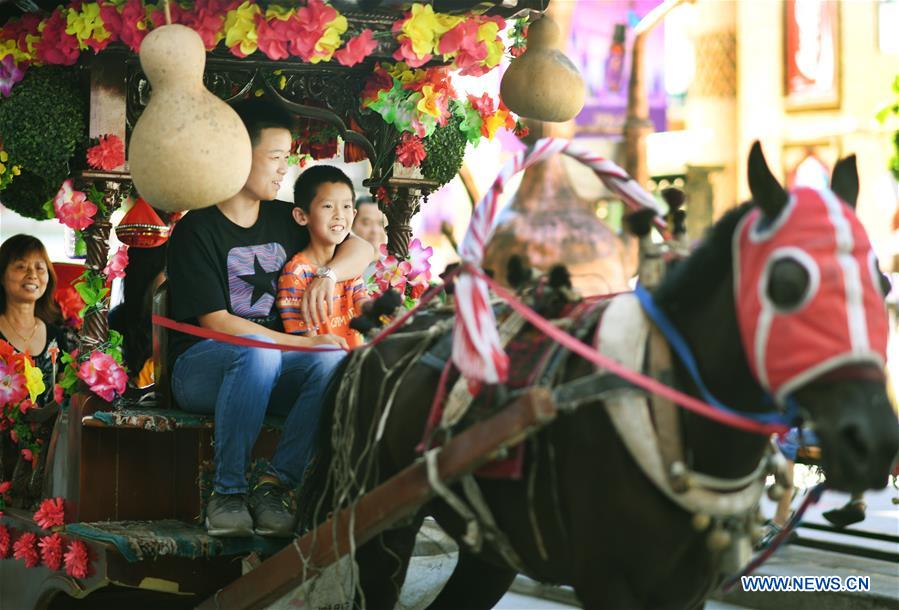 Tourists visit Int'l Bazar at Urumqi in NW China's Xinjiang