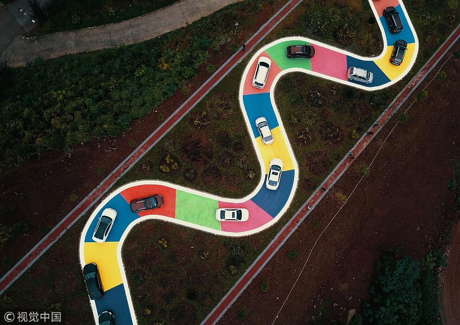Snakelike colorful road draws tourists