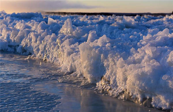 Yoga enthusiasts practice on frozen river in Heilongjiang