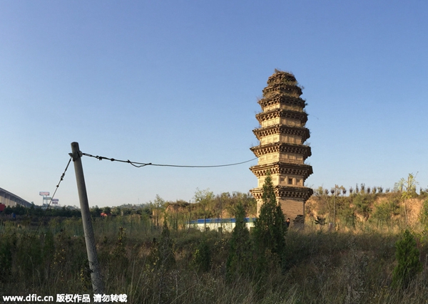 Leaning pagoda hooked by a cable wire