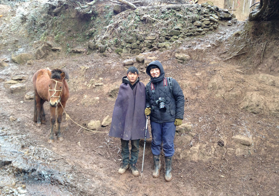 Young photographer takes family photos for mountain-dwellers