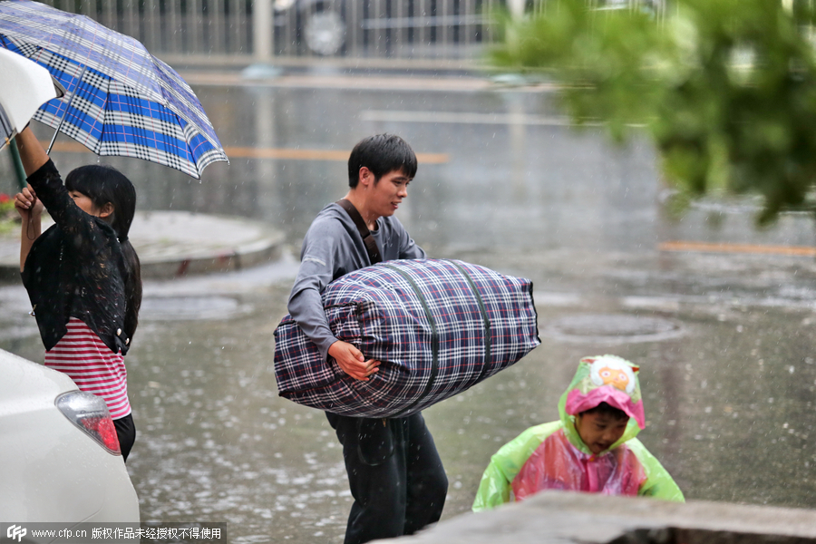 Downpour floods streets in Beijing, turns down summer heat