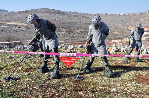 Chinese soldiers clear mines, win hearts