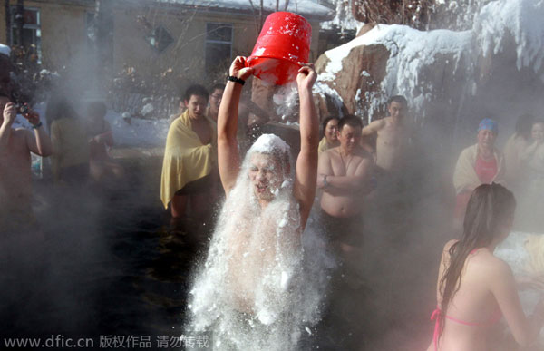 Girls in bikini pour ice in hot spring