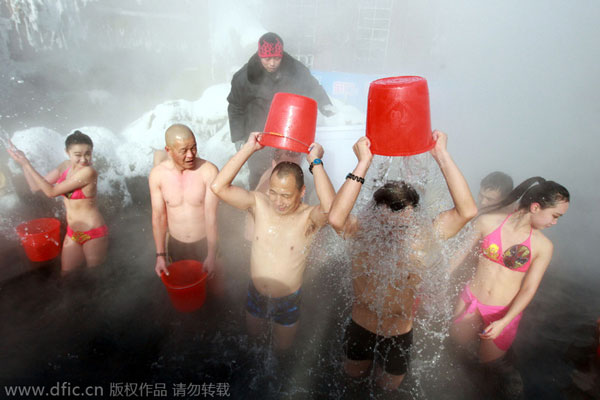 Girls in bikini pour ice in hot spring