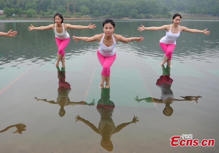 Yoga enthusiasts dance in water