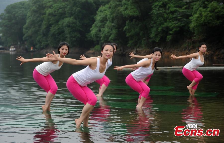 Yoga enthusiasts dance in water