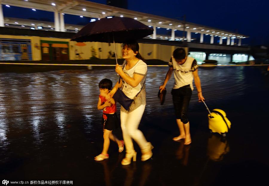 Family wades across flood to catch train