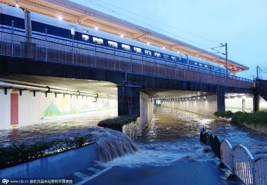 Family wades across flood to catch train