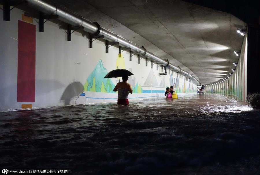 Family wades across flood to catch train