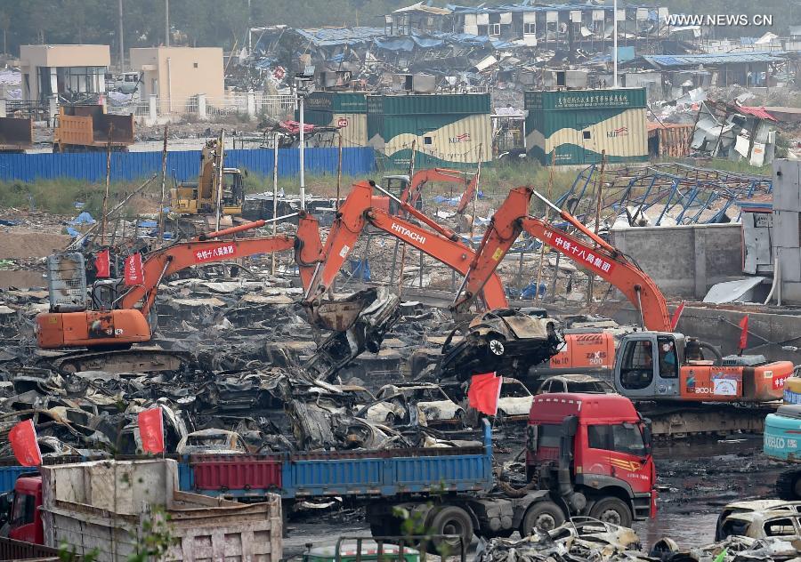 Burnt vehicles cleaned up in core blast area in Tianjin