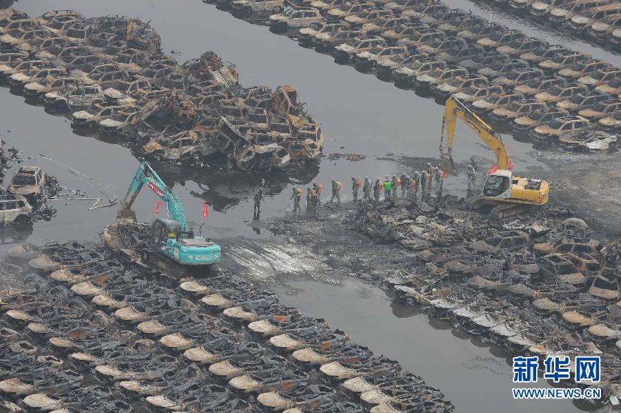 Burnt vehicles cleaned up in core blast area in Tianjin