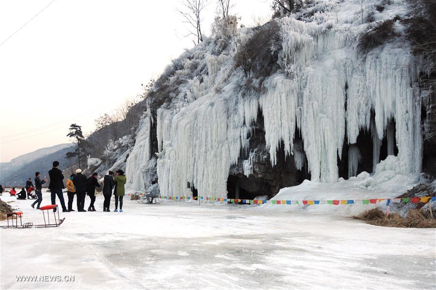 People take photos of frozen waterfalls in N China