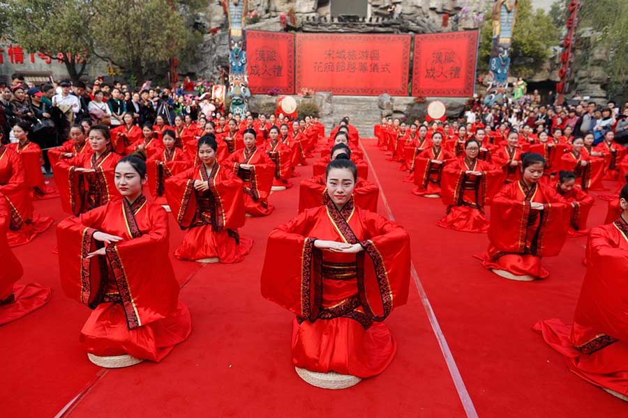 Students in traditional dresses celebrate Women's Day