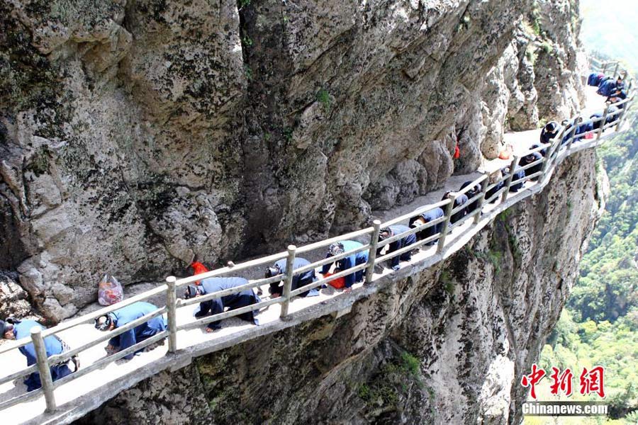 Taoist priests worship their ancestors by kneeling down on stone steps