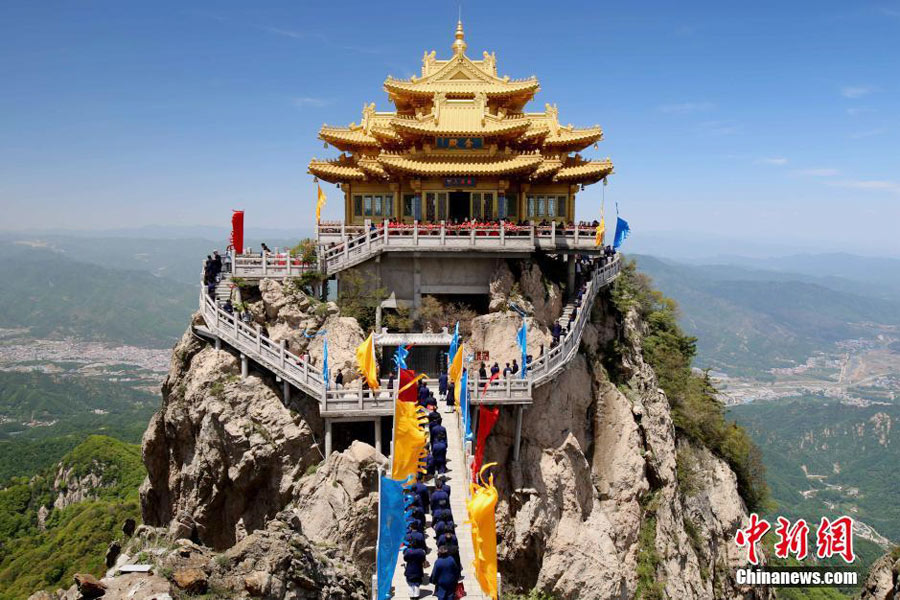 Taoist priests worship their ancestors by kneeling down on stone steps