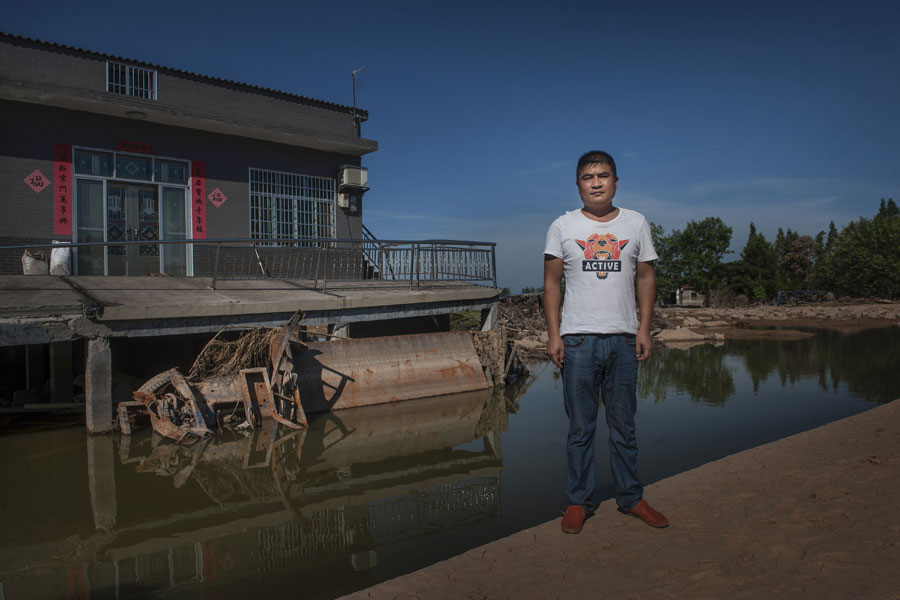 Residents sacrifice their vehicles to stop flood waters