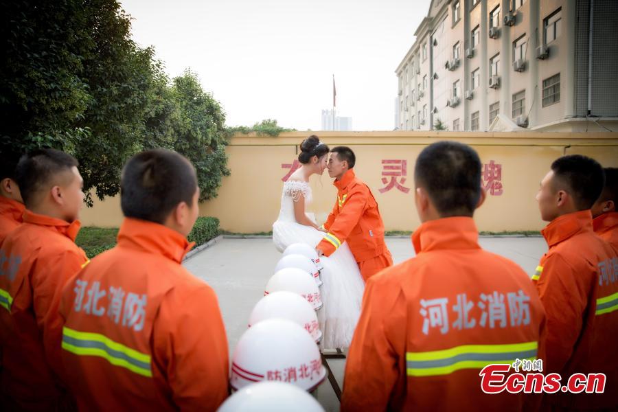 Firefighter poses for unconventional wedding photos