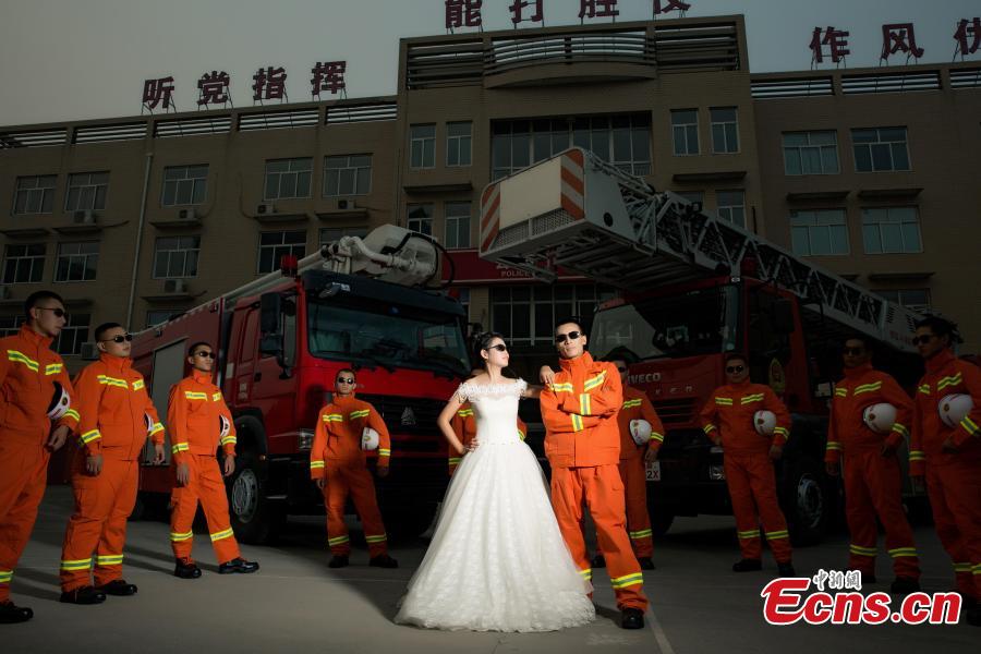 Firefighter poses for unconventional wedding photos