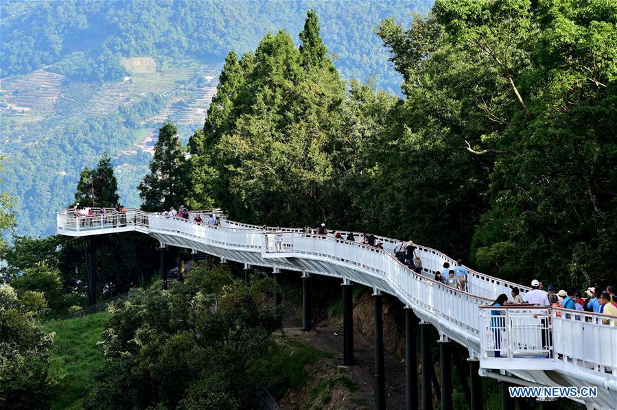 People enjoy scenery at high altitude sight-seeing footpath in Taiwan