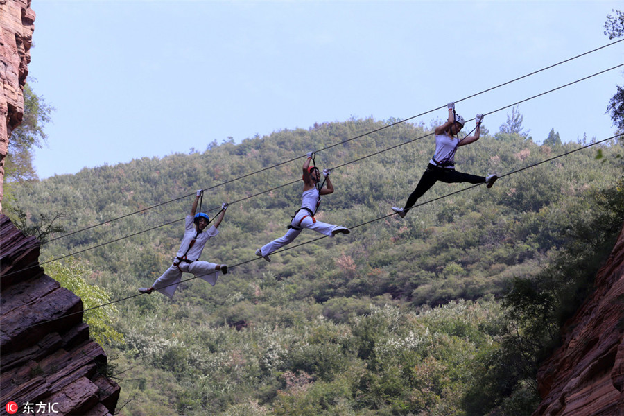 High on mountain: Yoga enthusiasts practice on cliff