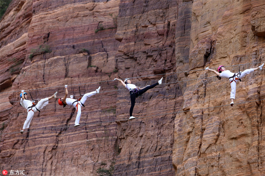 High on mountain: Yoga enthusiasts practice on cliff