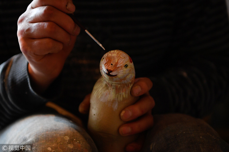 60-year-old villager paints potatoes for a living