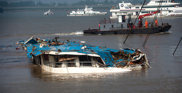 Crews raise capsized ship to assist search